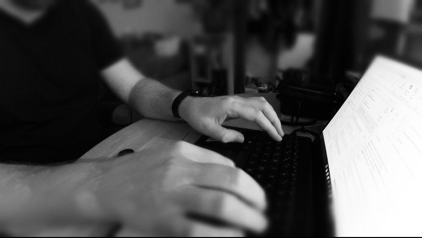 a picture of RIchard's hands on a keyboard with a laptop